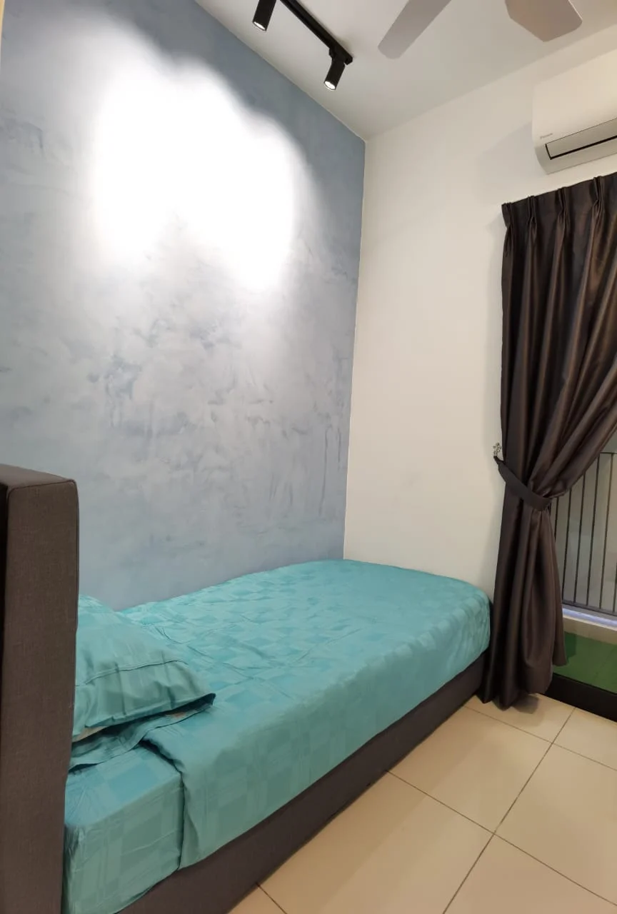 Bedroom features: single bed, turquoise bedspread, grey upholstered bed frame, blue accent wall with textured finish, cream painted walls, floor-to-ceiling window, dark curtains, wall-mounted air conditioning unit, ceiling fan with light, tile flooring; style: modern.